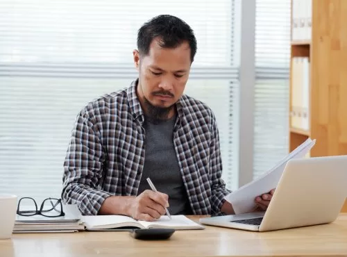 Freepik "Free photo casually dressed asian man working in office, writing in notebook and holding documents" by pressfoto